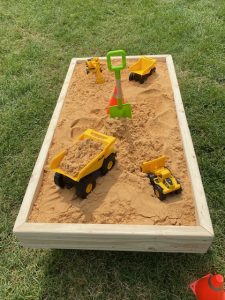 Sandbox with toy construction trucks at the National Night Out in Harford County