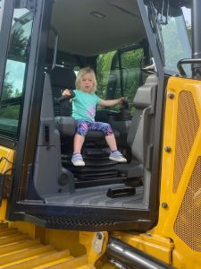 Child boards a heavy machinery display by Comer Construction at the National Night Out in Harford County
