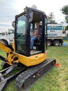 Kid boards a heavy machinery display by Comer Construction at the National Night Out in Harford County