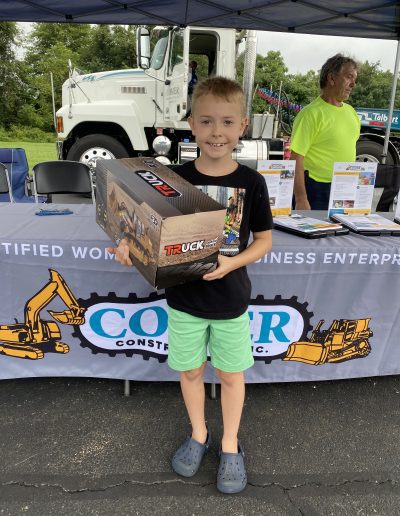 A boy with his toy truck prize