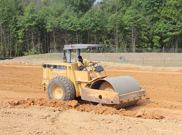 CAT Roller smoothing dirt at a job site