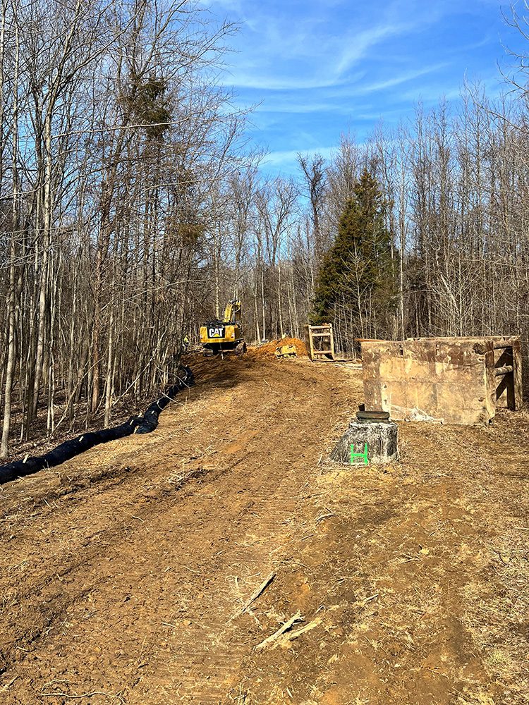 Worker installing speciality drainage system in Howard County, Maryland