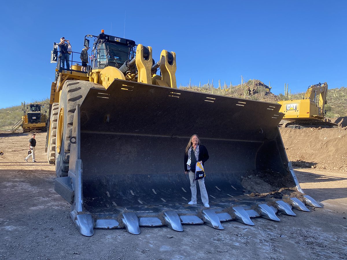 Bulldozer Leana Comer standing in a large bulldozer