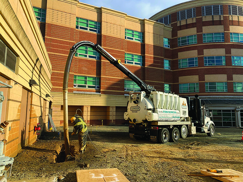 Hydro excavation truck digging near active hospital