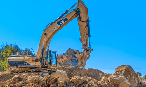 Excavator moving dirt