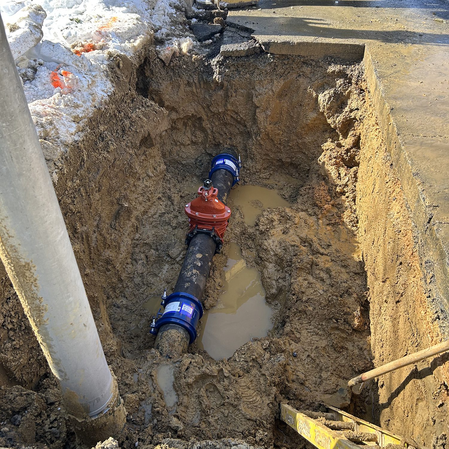 water main repair underground during snowy weather