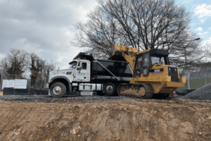 CAT 953C loading Comer dump truck