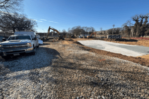 service truck in foreground, equipment across full site