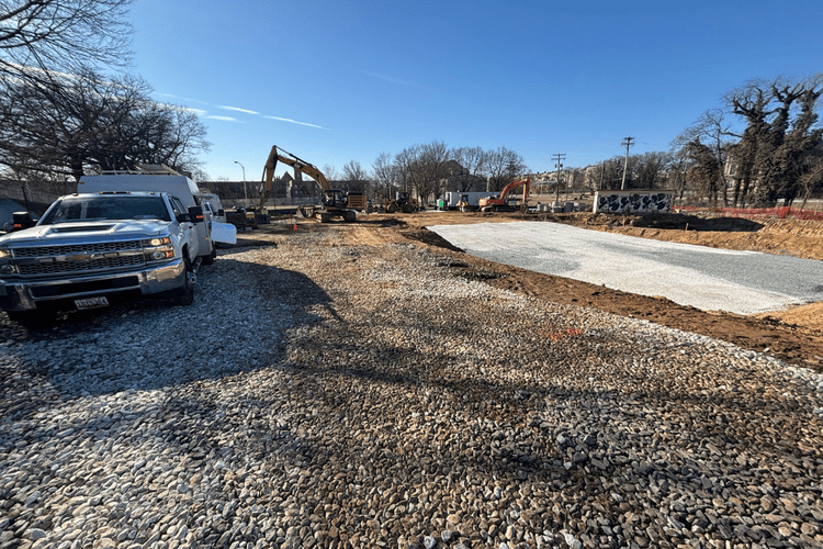 service truck in foreground, equipment across full site