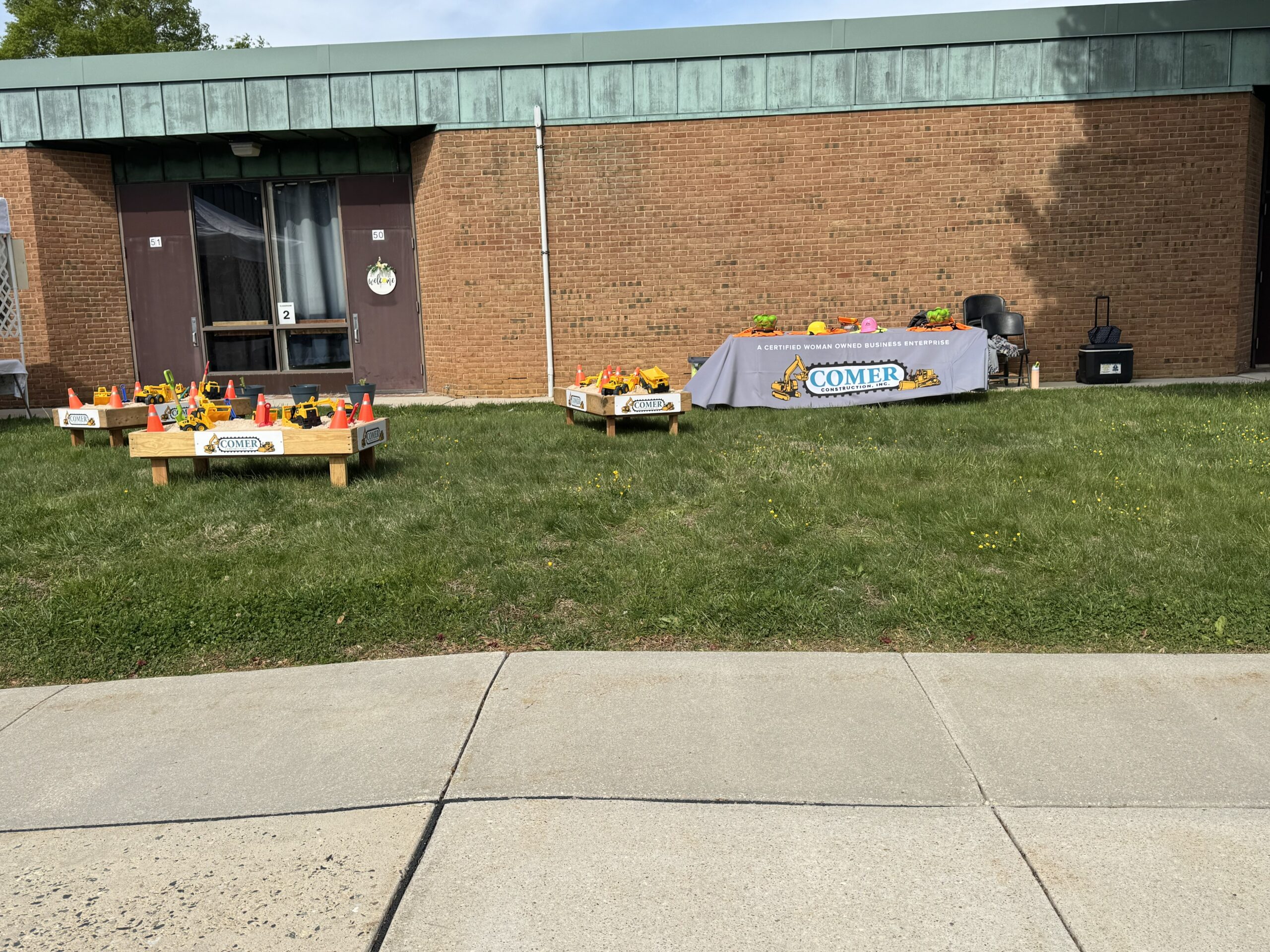 Comer Construction truck and table at touch a truck event
