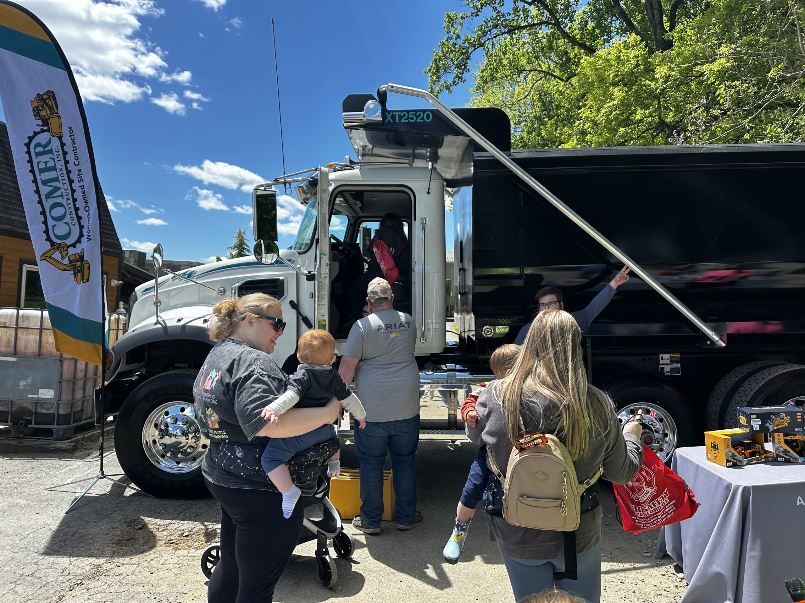 Comer Construction truck and table at touch a truck event