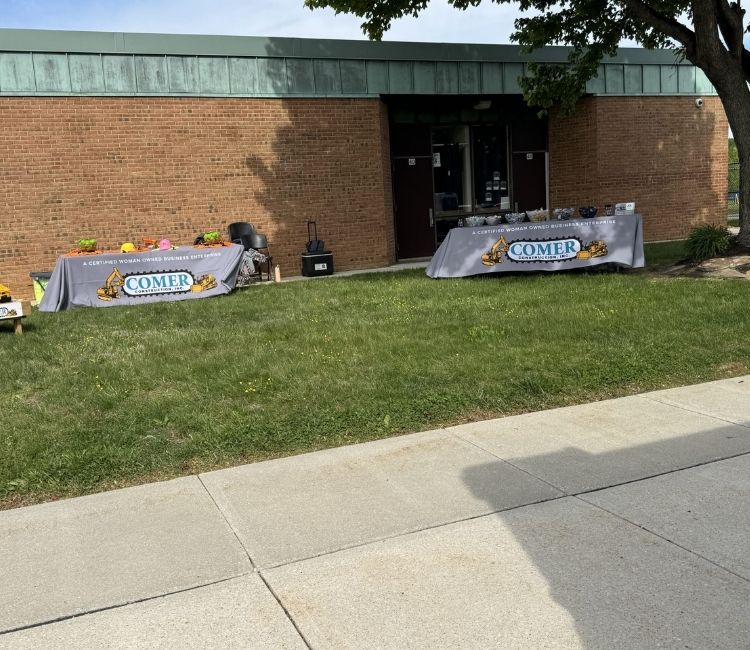 Event banners and display materials on the Harford Academy lawn.