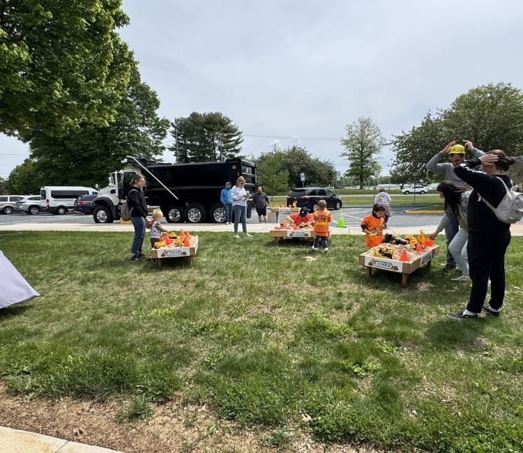 Children playing in construction-themed sandboxes.