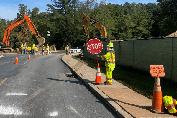 Maintenance of Traffic services along a road with an excavator working nearby