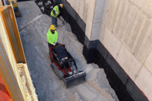 Crews working on leveling the ground near construction
