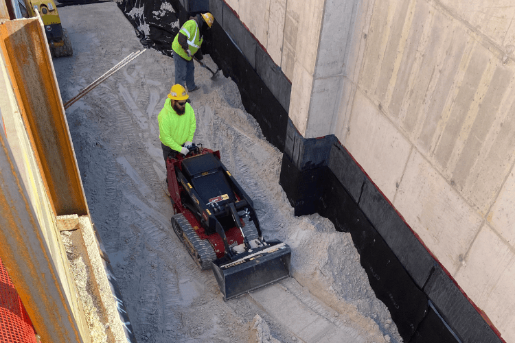 Crews working on leveling the ground near construction