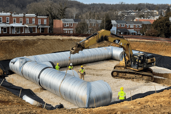 Crews installing a stormwater management system below grade
