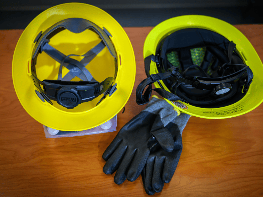 Side-by-side view of the inside of a traditional hard hat and a Type II safety helmet, showing the added padding and chin strap.